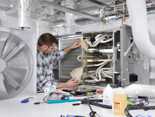 Pembroke Air Duct Cleaning specialist performing precision AC coil cleaning in Pembroke