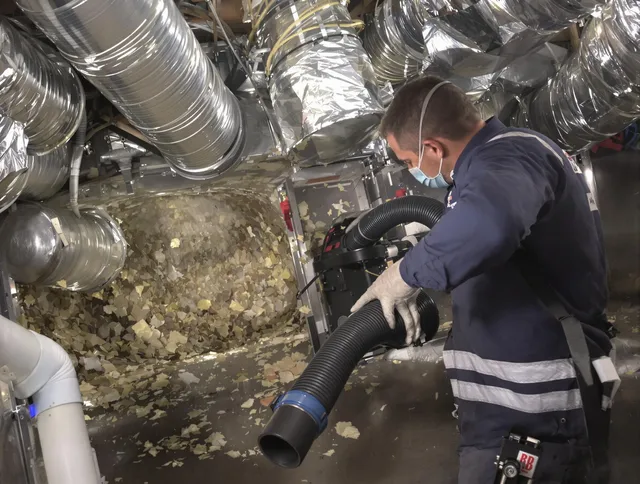 Pembroke Air Duct Cleaning specialist operating negative pressure cleaning equipment for thorough duct maintenance in Pembroke